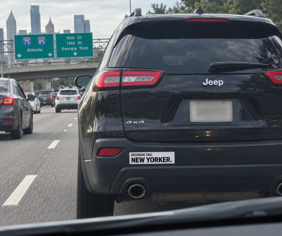 Concept rendering of a Georgia Tag, New Yorker bumper sticker on a car in traffic